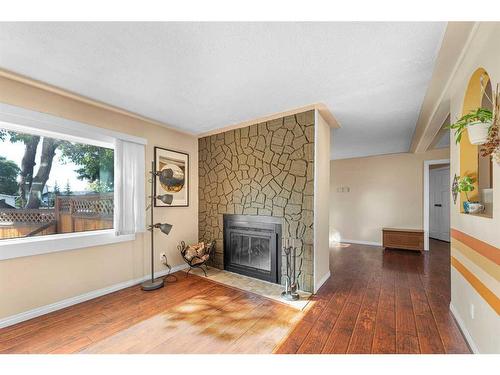 236 Huntwell Court Ne, Calgary, AB - Indoor Photo Showing Living Room With Fireplace