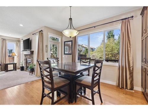 11 Silverado Skies Lane Sw, Calgary, AB - Indoor Photo Showing Dining Room With Fireplace