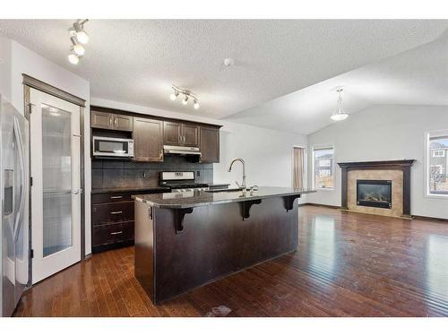 144 Evansborough Crescent Nw, Calgary, AB - Indoor Photo Showing Kitchen With Fireplace With Upgraded Kitchen