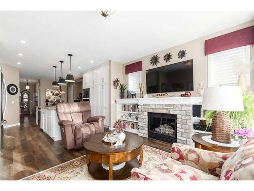 16 Emberside Green, Cochrane, AB - Indoor Photo Showing Living Room With Fireplace