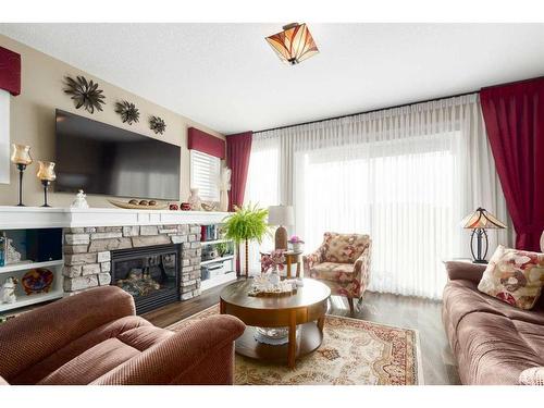 16 Emberside Green, Cochrane, AB - Indoor Photo Showing Living Room With Fireplace