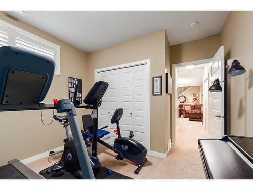 16 Emberside Green, Cochrane, AB - Indoor Photo Showing Gym Room