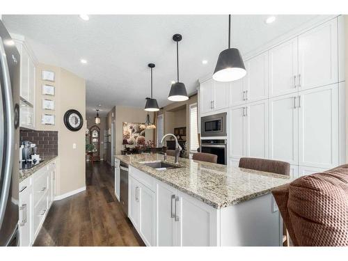 16 Emberside Green, Cochrane, AB - Indoor Photo Showing Kitchen With Upgraded Kitchen