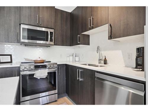 122-4 Sage Hill Terrace Nw, Calgary, AB - Indoor Photo Showing Kitchen With Double Sink With Upgraded Kitchen