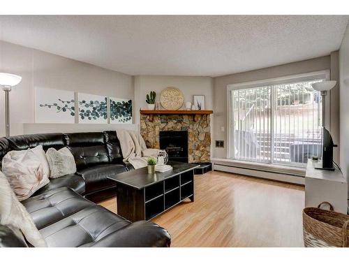 2135-70 Glamis Drive Sw, Calgary, AB - Indoor Photo Showing Living Room With Fireplace