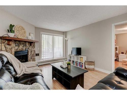 2135-70 Glamis Drive Sw, Calgary, AB - Indoor Photo Showing Living Room With Fireplace