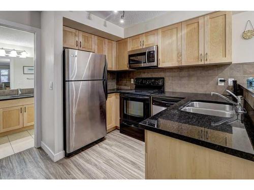 104-201 Muskrat Street, Banff, AB - Indoor Photo Showing Kitchen With Double Sink