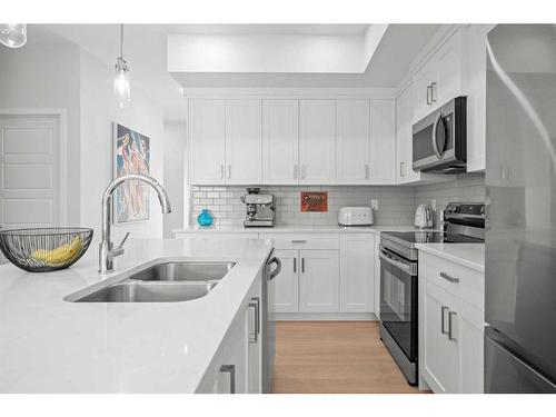 147-42 Cranbrook Gardens Se, Calgary, AB - Indoor Photo Showing Kitchen With Stainless Steel Kitchen With Double Sink With Upgraded Kitchen