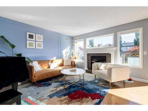 141 Cougar Ridge Circle Sw, Calgary, AB - Indoor Photo Showing Living Room With Fireplace