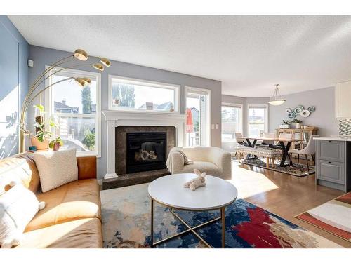 141 Cougar Ridge Circle Sw, Calgary, AB - Indoor Photo Showing Living Room With Fireplace