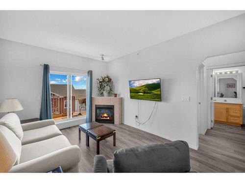 1304-70 Panamount Drive Nw, Calgary, AB - Indoor Photo Showing Living Room With Fireplace