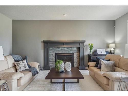 53 Sundown Grove, Cochrane, AB - Indoor Photo Showing Living Room With Fireplace