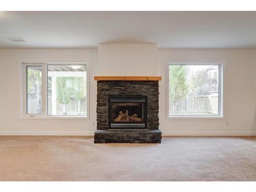 14 West Hall Place, Cochrane, AB - Indoor Photo Showing Living Room With Fireplace