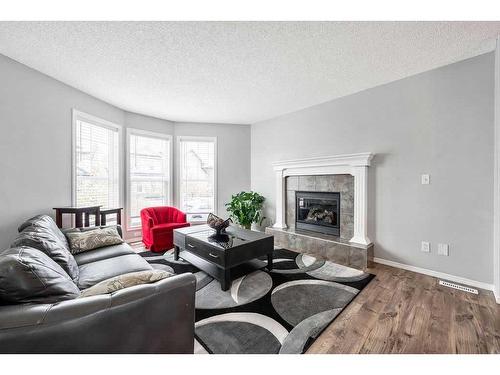 198 Cranberry Close Se, Calgary, AB - Indoor Photo Showing Living Room With Fireplace