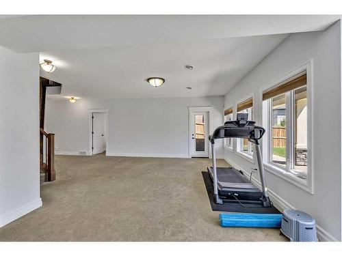 164 Kinniburgh Boulevard, Chestermere, AB - Indoor Photo Showing Gym Room