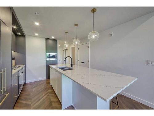 213-8505 Broadcast Avenue Sw, Calgary, AB - Indoor Photo Showing Kitchen With Double Sink With Upgraded Kitchen