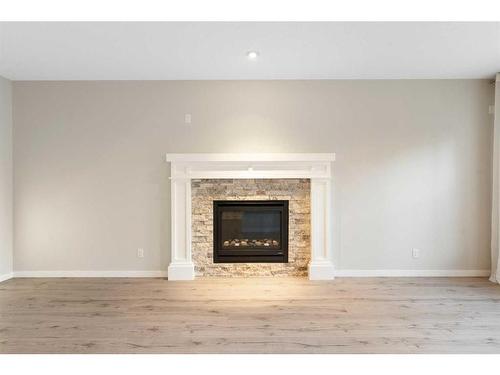 17 Riviera Place, Cochrane, AB - Indoor Photo Showing Living Room With Fireplace