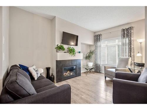 53 Copperpond Landing Se, Calgary, AB - Indoor Photo Showing Living Room With Fireplace