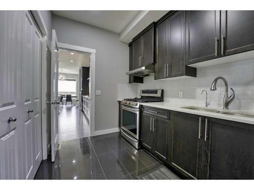 239 Hillcrest Heights Sw, Airdrie, AB - Indoor Photo Showing Kitchen With Double Sink