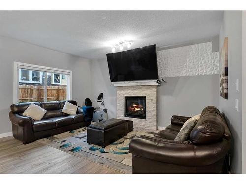 247 Kinniburgh Road, Chestermere, AB - Indoor Photo Showing Living Room With Fireplace