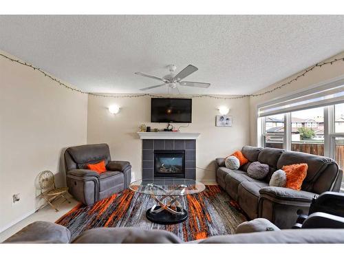 51 Saddlecrest Gardens Ne, Calgary, AB - Indoor Photo Showing Living Room With Fireplace