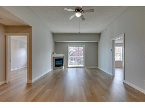 315-2233 34 Avenue Sw, Calgary, AB - Indoor Photo Showing Living Room With Fireplace