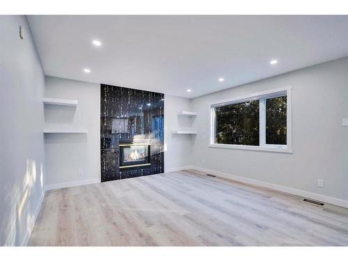 59 Douglas Shore Close Se, Calgary, AB - Indoor Photo Showing Living Room With Fireplace