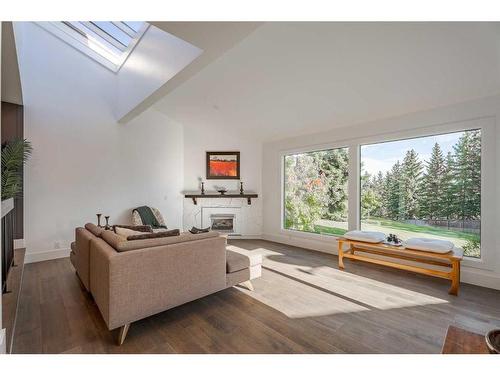 8 Coach Manor Rise Sw, Calgary, AB - Indoor Photo Showing Living Room With Fireplace