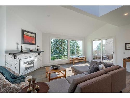 8 Coach Manor Rise Sw, Calgary, AB - Indoor Photo Showing Living Room With Fireplace