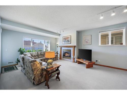 34-99 Christie Point Sw, Calgary, AB - Indoor Photo Showing Living Room With Fireplace