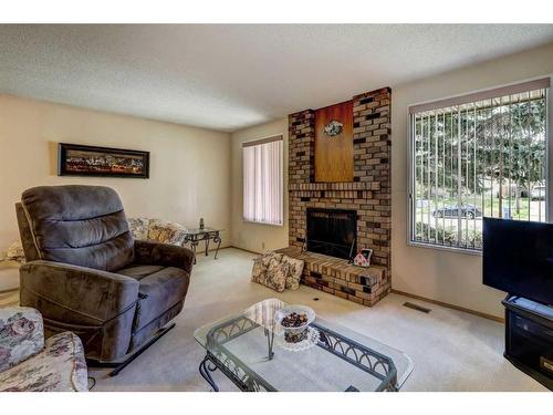 6 Radcliffe Crescent Se, Calgary, AB - Indoor Photo Showing Living Room With Fireplace