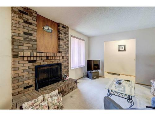 6 Radcliffe Crescent Se, Calgary, AB - Indoor Photo Showing Living Room With Fireplace