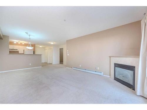 4111-4975 130 Avenue Se, Calgary, AB - Indoor Photo Showing Living Room With Fireplace