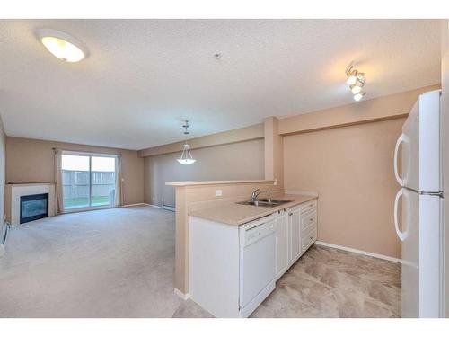 4111-4975 130 Avenue Se, Calgary, AB - Indoor Photo Showing Kitchen With Fireplace With Double Sink