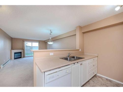 4111-4975 130 Avenue Se, Calgary, AB - Indoor Photo Showing Kitchen With Fireplace With Double Sink