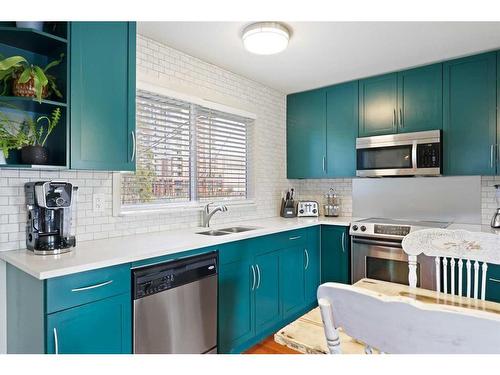 12 Harmon Place Sw, Calgary, AB - Indoor Photo Showing Kitchen With Double Sink