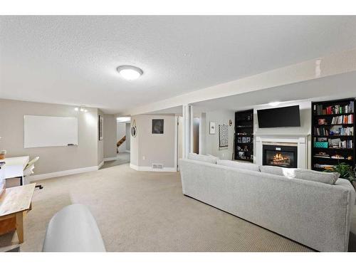 12 Harmon Place Sw, Calgary, AB - Indoor Photo Showing Living Room With Fireplace