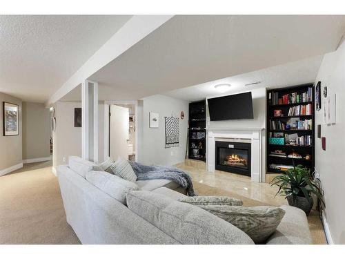 12 Harmon Place Sw, Calgary, AB - Indoor Photo Showing Living Room With Fireplace