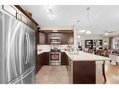 3112-4 Kingsland Close Se, Airdrie, AB - Indoor Photo Showing Kitchen With Stainless Steel Kitchen With Double Sink With Upgraded Kitchen