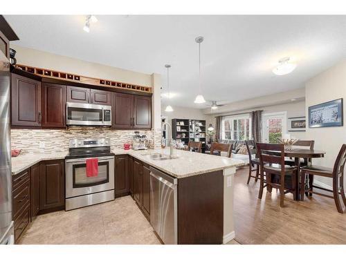 3112-4 Kingsland Close Se, Airdrie, AB - Indoor Photo Showing Kitchen With Stainless Steel Kitchen With Double Sink With Upgraded Kitchen