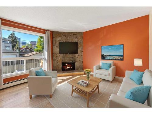 105-205 5 Avenue Ne, Calgary, AB - Indoor Photo Showing Living Room With Fireplace