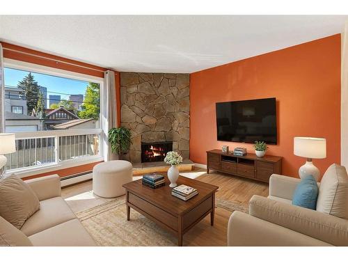 105-205 5 Avenue Ne, Calgary, AB - Indoor Photo Showing Living Room With Fireplace