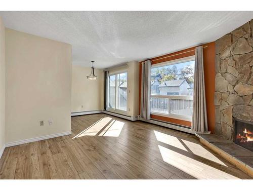 105-205 5 Avenue Ne, Calgary, AB - Indoor With Fireplace