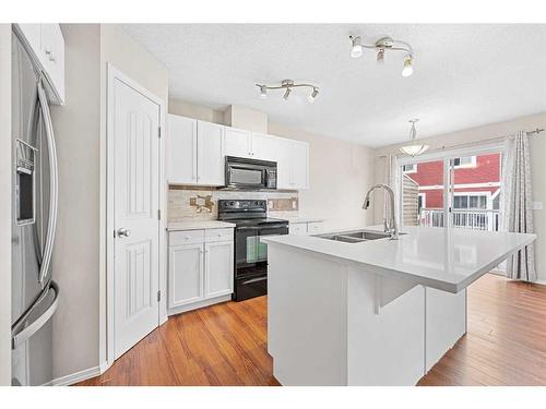 503-800 Yankee Valley Boulevard Se, Airdrie, AB - Indoor Photo Showing Kitchen With Double Sink With Upgraded Kitchen