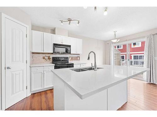 503-800 Yankee Valley Boulevard Se, Airdrie, AB - Indoor Photo Showing Kitchen With Double Sink