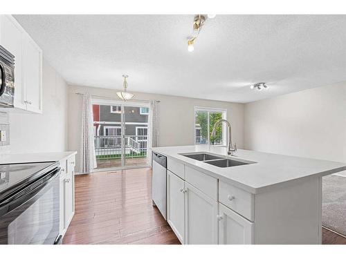 503-800 Yankee Valley Boulevard Se, Airdrie, AB - Indoor Photo Showing Kitchen With Double Sink