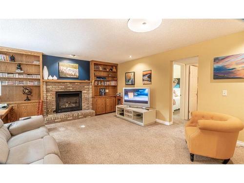 104 Millbank Close Sw, Calgary, AB - Indoor Photo Showing Living Room With Fireplace