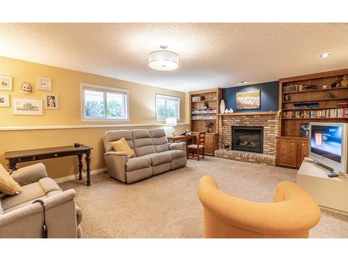 104 Millbank Close Sw, Calgary, AB - Indoor Photo Showing Living Room With Fireplace