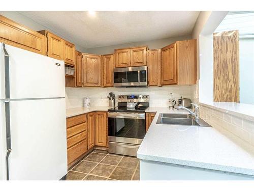 104 Millbank Close Sw, Calgary, AB - Indoor Photo Showing Kitchen With Double Sink