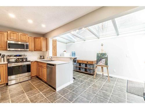 104 Millbank Close Sw, Calgary, AB - Indoor Photo Showing Kitchen With Double Sink